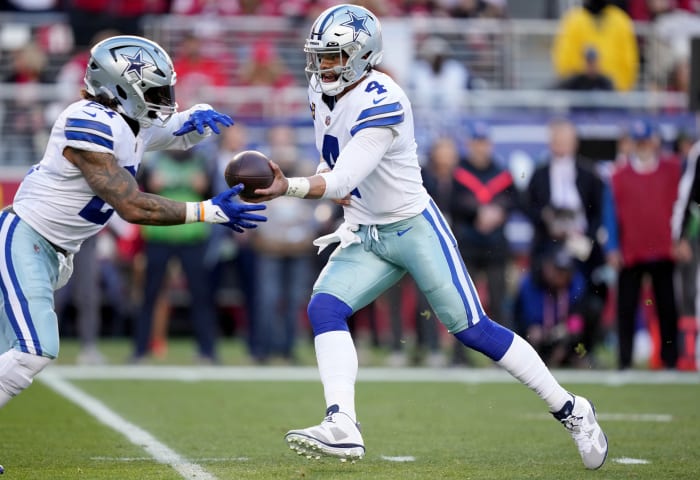 Cowboys quarterback Dak Prescott hands off to running back Ezekiel Elliott.